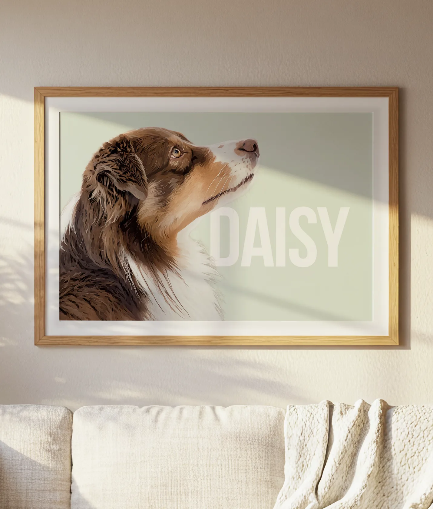The dog Daisy in a modern painting, framed in a natural frame and with a passepartout. The painting has a light green background color and white, nicely typographically designed text that partially goes behind the dog's head.